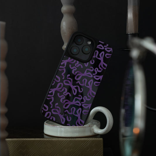 Phone case with purple abstract pattern on a white mug against a dark background