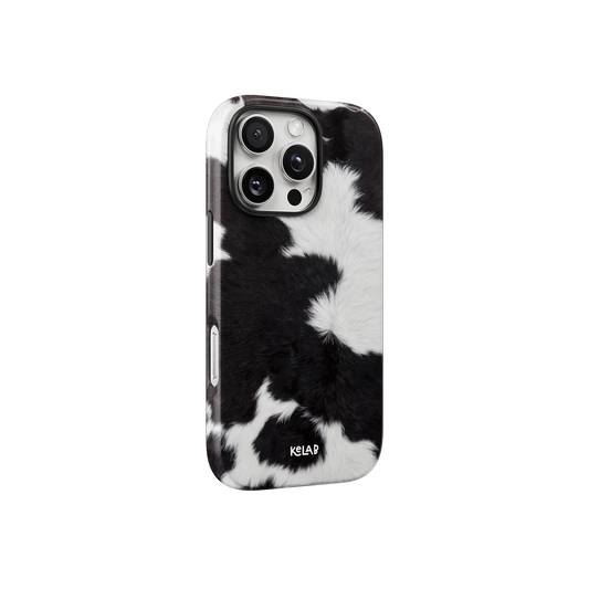 Side view of the KELAB Black & White Cow Print iPhone Case showcasing its sleek fit and high-contrast cowhide design for a minimalist, editorial style.