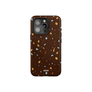 Brown marble terrazzo phone case by KELAB featuring a deep cocoa base with ochre, blue, and tan speckles. Stylish protection for iPhone models.