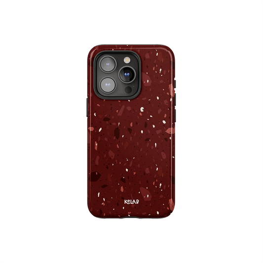 Burgundy marble terrazzo phone case by KELAB with crushed garnet tones and blush flecks, designed for iPhone with camera cutout.