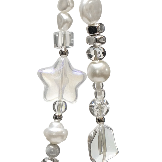 Close-up of KELAB's Cosmic Pearl phone charm showing glittery star, pearl accents, and faceted crystal beads for a dreamy celestial look.