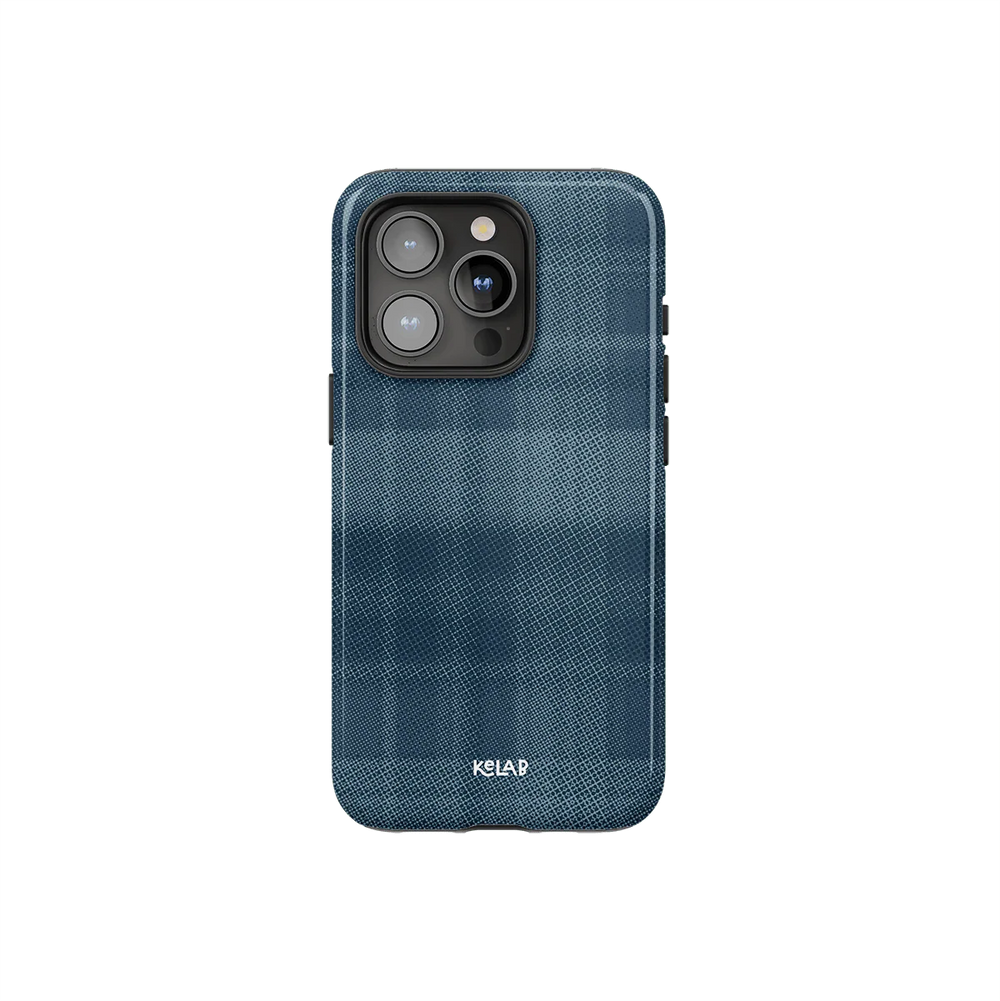 Minimalist iPhone case with blue flannel design by KELAB featuring a checkered pattern and subtle texture. Stylish and protective phone accessory.