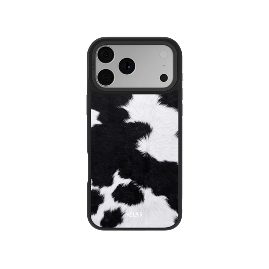Black and white cow print phone case, made of soft fur material, stylish and protective for iPhone.