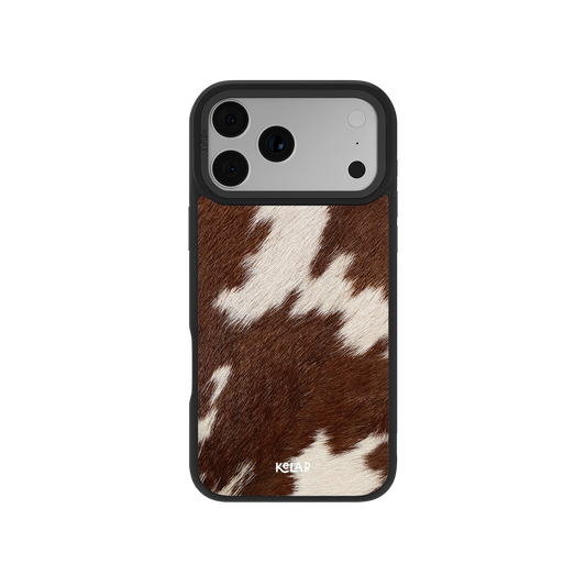 Brown and white cowhide phone case for iPhone, sleek design with durable black edges.