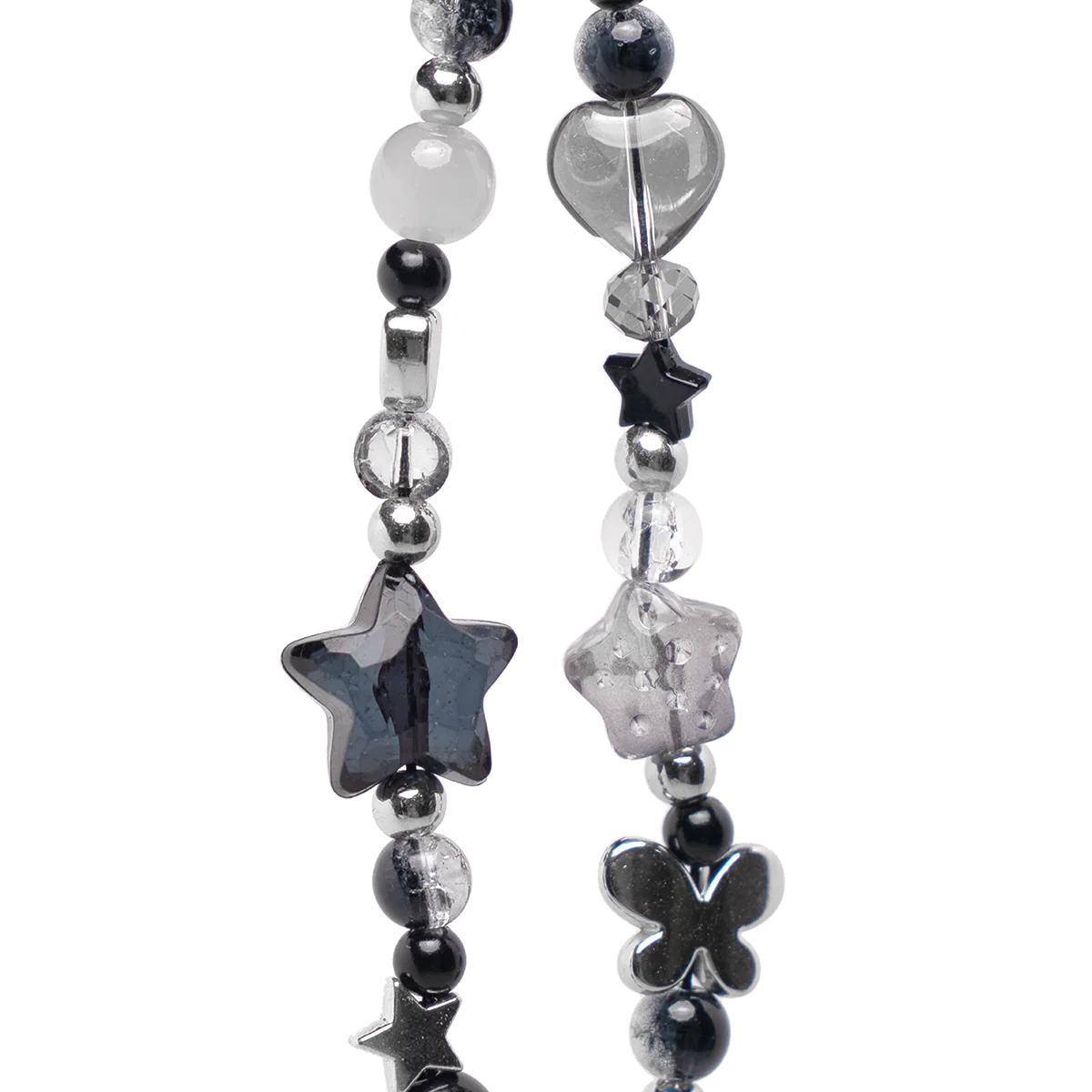 Close-up of chrome phone charm showing star, heart, and butterfly beads in black and crystal tones. Edgy Y2K aesthetic for iPhone accessories.