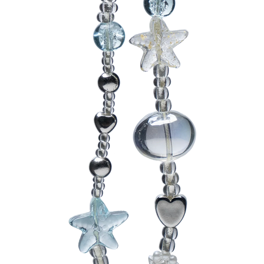 Close-up of Crystal Sea Star Phone Charm showing detailed heart, shell, and star beads in metallic and translucent finishes.